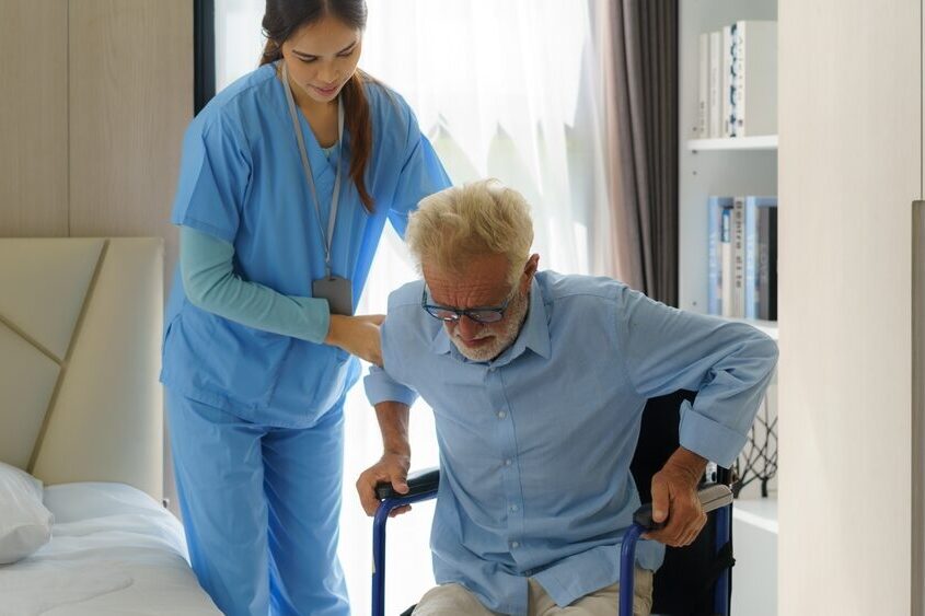 Home asian,smiling,nurse,helping,senior,man,get,out,of,bed